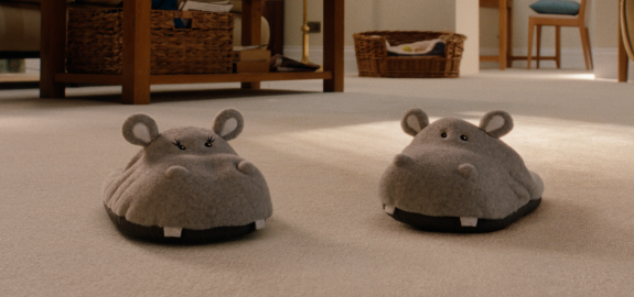 Pamela & Briar, a pair of hippo slippers on a cream twist carpet